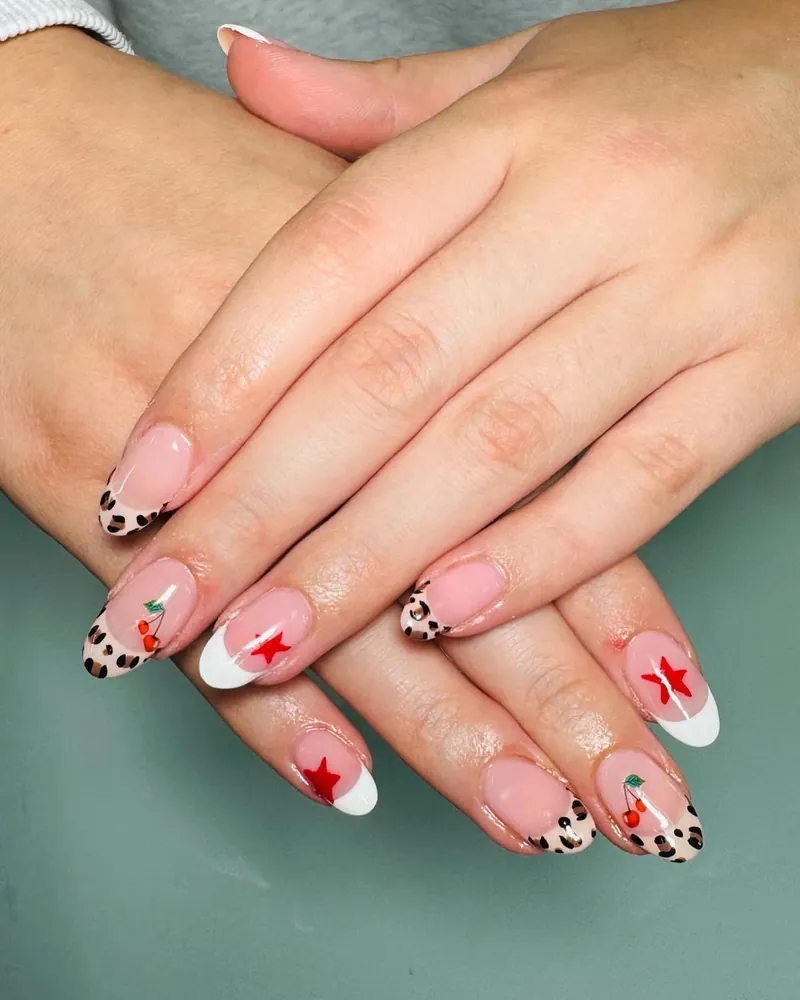 French tip nails mixed with red stars and leopard print accents